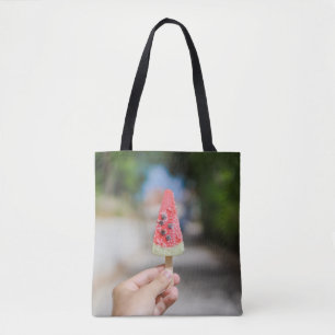 Person holding popsicle in the morning tote bag