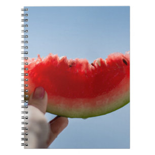 Person holding sliced watermelon notebook