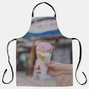 Person holding strawberry ice cream apron