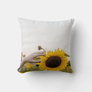 Person holding sunflower cushion
