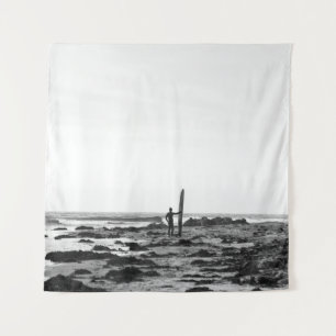 PERSON HOLDING SURFBOARD NEAR BODY OF WATER TAPESTRY