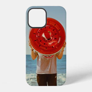 Person holding watermelon-themed inflatable ring iPhone 12 case