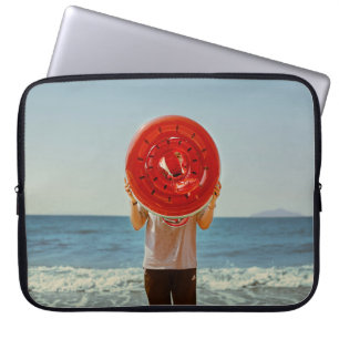 Person holding watermelon-themed inflatable ring laptop sleeve