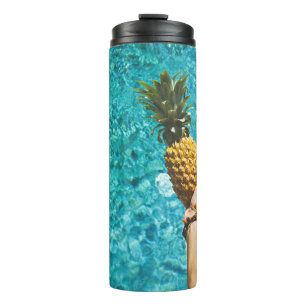 Person holding yellow pineapple thermal tumbler