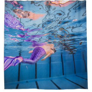 Person in purple pants lying on blue hammock shower curtain