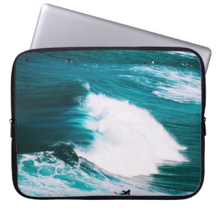 Person on surfboard with ocean waves laptop sleeve