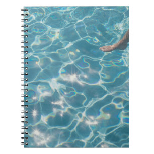 Person on swimming pool notebook