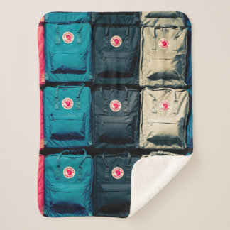 Person showing assorted-colour bags sherpa blanket