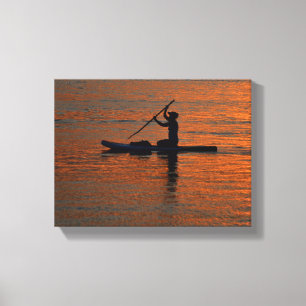 Person silhoutte kayaking at river canvas print