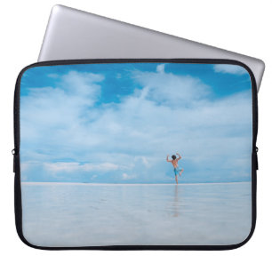 Person standing in body of water laptop sleeve