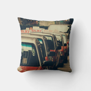 PERSON STANDING NEAR PARKED TAXI DURING DAYTIME CUSHION