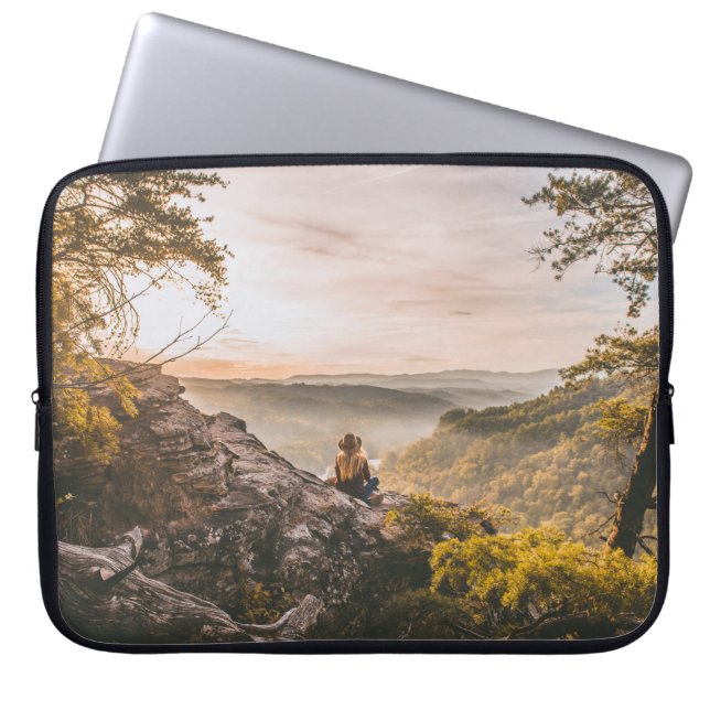 PERSON STANDING ON CLIFF NEAR TREE ON MOUNTAIN LAPTOP SLEEVE (Front)