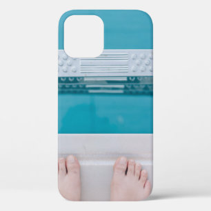 Person standing on swimming pool ladder iPhone 12 case