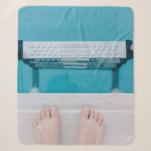Person standing on swimming pool ladder sherpa blanket