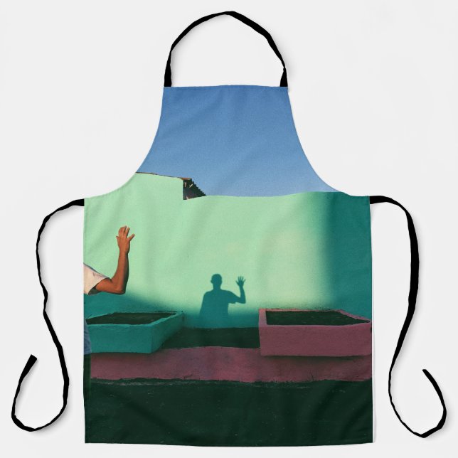 Person waving reflecting shadow on teal wall paint apron (Front)