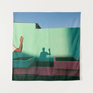 Person waving reflecting shadow on teal wall paint tapestry