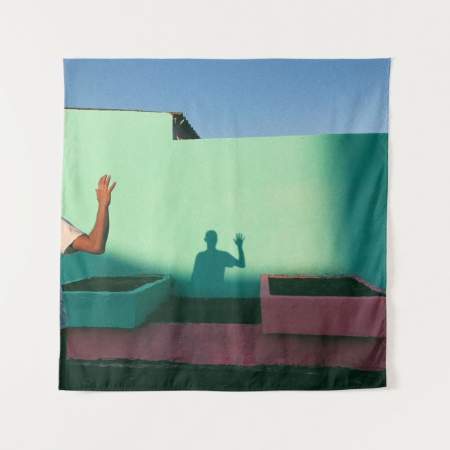 Person waving reflecting shadow on teal wall paint tapestry (Front)
