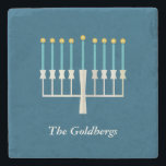 Personalised Family Name Hanukkah Menorah Blue Stone Coaster<br><div class="desc">Celebrate Hanukkah with this elegant personalised stone coaster featuring a beautifully designed menorah on a classic blue background. Perfect for adding a festive touch to your home decor, this coaster makes a thoughtful holiday gift or a stylish addition to your Hanukkah table setting. Customise with a family name for a...</div>