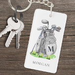 Personalised Golfer Monogram Key Ring<br><div class="desc">This elegant monogram keychain features a stylish grey watercolor golf bag filled with clubs, surrounded by a touch of green grass. The design incorporates a simple serif font initial monogram on the bag, blending seamlessly into the overall design. Below the monogram, the full name is displayed in a matching serif...</div>