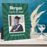 Personalised Green Class of 2025 Graduation Photo Plaque<br><div class="desc">Modern and minimal plaque display sign with easel for the graduation party will showcase your graduate! Design features a square photo of the grad framed in white with simple and classic first name, class year, and school name wording that can be personalised. Includes a subtle starburst pattern. Dark green background...</div>
