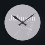 Personalised Modern Family Name Round Clock<br><div class="desc">This is a stylish, modern, grey, personalised, family name design. It is in trending grey with stylish script typography. This chic design is ideal as personalised gift or perfect as a new addition to your home decor. To personalise, simply add your name in the personalise this text box. To change...</div>