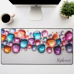 Personalised Rainbow Gemstone  Desk Mat<br><div class="desc">Bring a touch of magic and sparkle to your workspace with this personalised desk mat adorned with vibrant rainbow gemstones. The colourful crystals, set against a sleek black background, create a mesmerising and inspiring scene. Make it truly yours by adding your name or a motivational quote. The smooth surface provides...</div>
