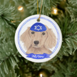 Personalised Red English Dachshund Dog Hanukkah Ceramic Tree Decoration<br><div class="desc">Celebrate your favourite mensch on a bench with personalised ornament! This design features a sweet illustration of a red english long haired dachshund dog with a blue and white yarmulke. For the most thoughtful gifts, pair it with another item from my collection! To see more work and learn about this...</div>