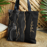 Personalised Signature Black Gold Agate Tote Bag<br><div class="desc">Personalise this elegant modern design with your name in vertical gold-coloured signature handwriting script on a black background with a border of black watercolor agate trimmed with gold faux glitter. (To keep the swashes at the beginning and end of the name, replace only the letters, leaving the symbols in place.)...</div>