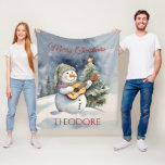Personalised Snowman Guitar Christmas Fleece Blanket<br><div class="desc">Wrap yourself in warmth and joy with our Snowman Guitar Christmas Fleece Blanket. Luxurious softness meets festive design,  making it a perfect holiday gift! Add that special name for that special touch! Exclusive designs from My Baby Boutique!</div>