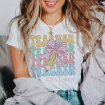 Personalised With Name Pink Bow Teacher Custom T-Shirt<br><div class="desc">Elevate your teaching wardrobe with our Personalised With Name Pink Bow Teacher Custom T-Shirt, a symbol of style and dedication. This tee blends classic sophistication with a touch of whimsy, featuring a charming pink bow design that adds a retro-coquette vibe. Whether you're a seasoned educator or embarking on a new...</div>
