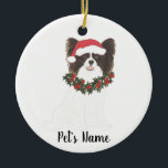 Personalized Black & White Papillon Christmas Ceramic Tree Decoration<br><div class="desc">Make the nice list this year with a personalized Christmas ornament of your sweet black and white papillon in a santa hat and red and green holly wreath! For the sweetest gifts,  pair it with a matching art print or another item from my collection!</div>