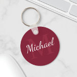 Personalized Monogram and Name Burgundy Red Key Ring<br><div class="desc">Personalized Monogram and Name Gift
features personalized name in white script font style and monogram in light burgundy red serif font style as background,  on burgundy red background.

Perfect as holiday gift,  family reunion favors,  thank you gift for groomsmen and gift for any special occasions.</div>