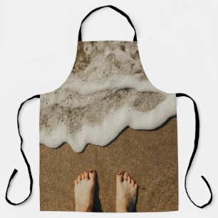 Person's feet on seashore apron