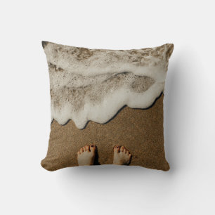 Person's feet on seashore cushion