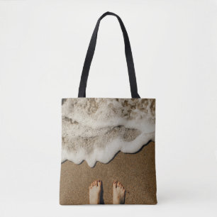 Person's feet on seashore tote bag