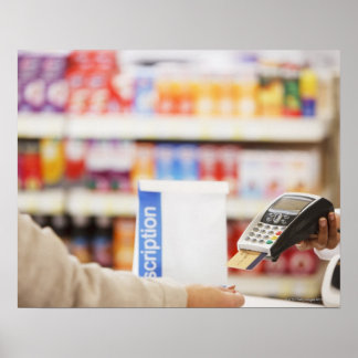 Pharmacist holding security device for customer poster