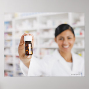 Pharmacist in drug store holding out pill bottle poster