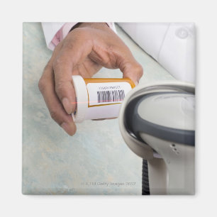 Pharmacist scanning pill bottle with a barcode magnet