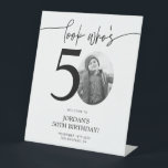 Photo 50th Birthday Welcome Sign | Look Who's 50<br><div class="desc">Welcome guests to your 50th birthday celebration with this stunning editable welcome sign. Featuring a sleek, customizable layout, this template allows you to easily add your own photo and personalize the text, making it a perfect addition to your milestone 50th birthday decor. Ideal for entryways or as a party focal...</div>