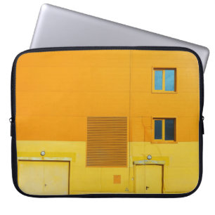 PHOTO OF YELLOW AND WHITE PAINTED WALL LAPTOP SLEEVE