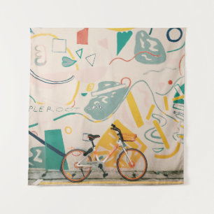 PHOTOGRAPHY OF ORANGE AND WHITE BICYCLE TAPESTRY