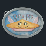 Pie in the Sky Retro Winged Cutie Oval Belt Buckle<br><div class="desc">This cute belt buckle shows a pie in the sky on a blue cloudy sky background with a grunge effect added to make it look antique, alongside the words "Cutie Pie" in a retro style. The pie has a smiling face and light pink wings. It's made up of elements from...</div>