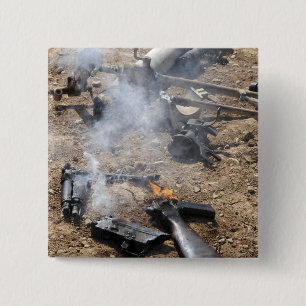Pieces of enemy weapons lay out to cool off 15 cm square badge