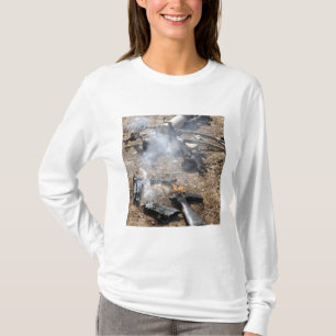 Pieces of enemy weapons lay out to cool off T-Shirt