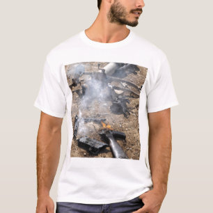 Pieces of enemy weapons lay out to cool off T-Shirt