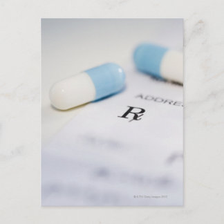 Pills on written prescription postcard