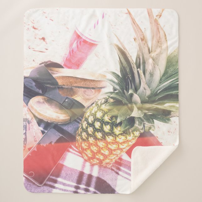Pineapple beside phone and speaker sherpa blanket (Front)