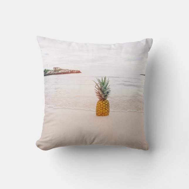 Pineapple on sand near beach cushion (Front)