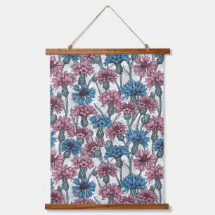 Pink and blue cornflowers on white hanging tapestry