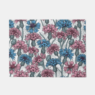 Pink and blue cornflowers, wild flowers on white doormat